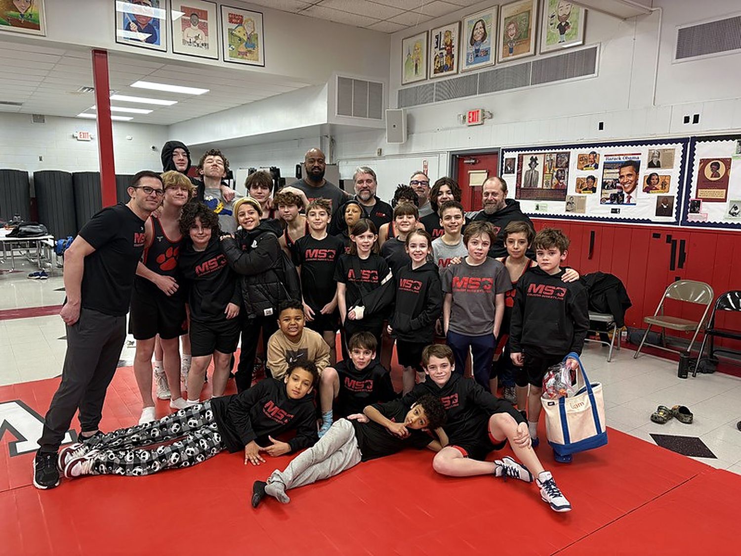 The MSO Wrestling team and coaches together on the mat after practice.